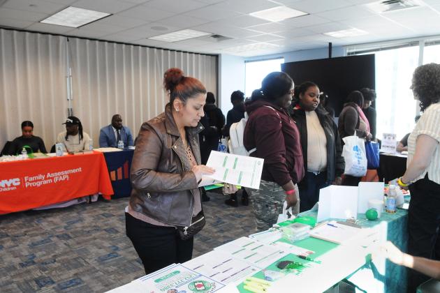 Yajaira Martinez, a parent of students at William H. Maxwell HS in Brooklyn’s East New York and MS 67 in Little Neck, Queens, browses the UFT’s Dial-A-Teacher table during the resource and vendor expo.