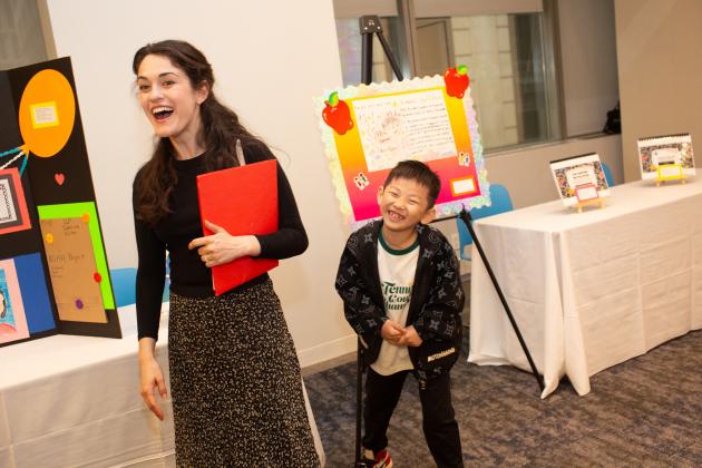 Speech teacher Rachel Bases of PS 250 in Brooklyn and her student Alston share a laugh before the start of the UFT Speech Improvement Chapter's Better Speech and Hearing Month Celebration. 