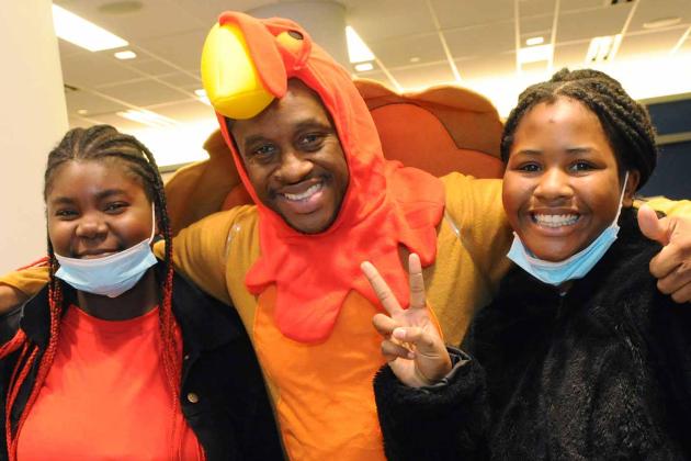 Students pose with a teacher in costume