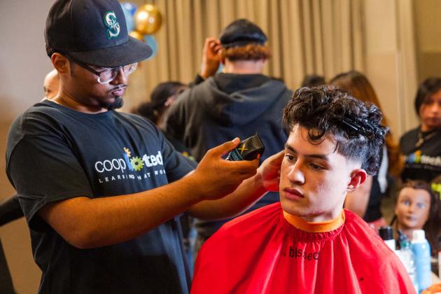 Barbering students from Manhattan’s Coop Tech demonstrate their skills with scissors and clippers.