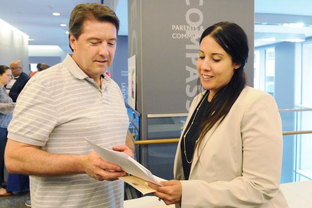 Two UFT chapter leaders looking at piece of paper