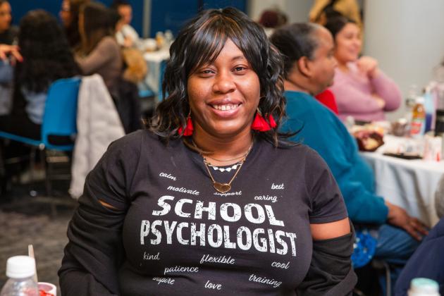 Sharon Gerrick, a school psychologist in District 18 in Brooklyn, smiles for a photo while wearing a school psychologist shirt during Clinician Appreciation Day at UFT headquarters on Jan. 27, 2025.