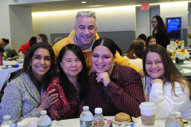 A group of school social workers take a photo at a table during the 2026 UFT Clinician's Appreciation Day