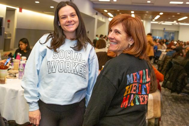 Two social workers in attendance at 2025 Clinicians Appreciation Day smile while taking a photo. 