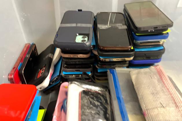 Cellphones being collected during summer school