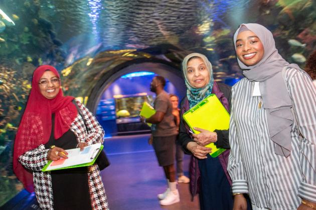 Three women visiting an aquarium.