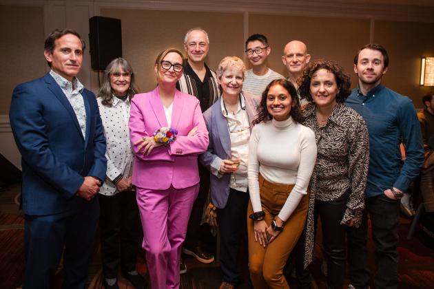 Honoree Brenna McLaughlin (wearing pink), a photo teacher at Art and Design HS in Manhattan, celebrates with co-workers before the 2025 UFT Career and Technical Education Awards at the Sheraton New York Times Square Hotel on Feb. 26, 2025.