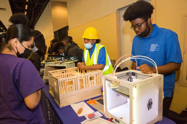 Brooklyn Steam Center Navy Yard students show off a 3D printer and a model they made.