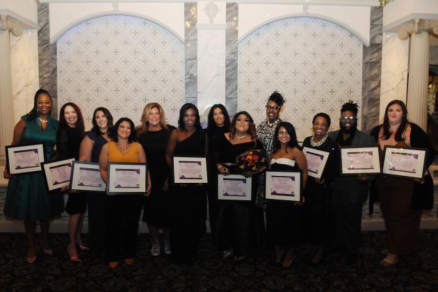 Award-winning UFT members beam as they show off their plaques at the UFT District 11 Scholarship Dinner on March 28, 2025. 