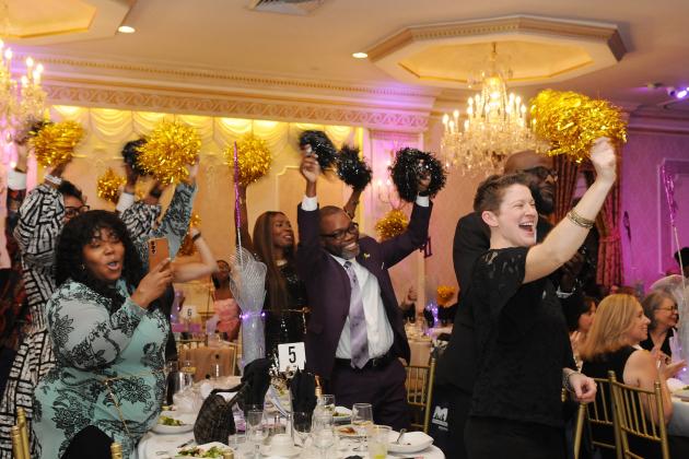 Members from MS 462 in the Bronx cheer on their colleague as she receives an award at the 2025 UFT District 11 Scholarship Dinner.