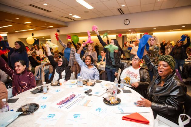Attendees at the UFT Early Childhood Conference on April 5, 2025 wave their napkins to the beat of the music performances.