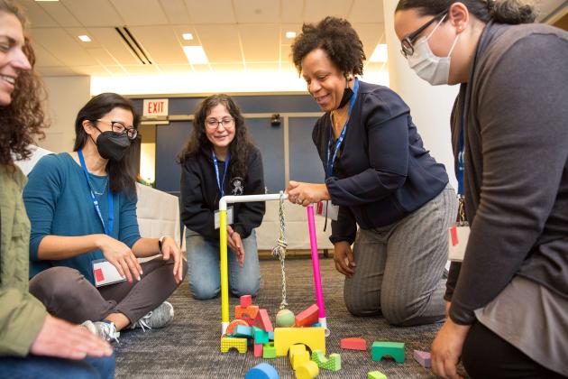 Playing in a workshop on gross motor skills are (from left) Halley Gerstel from the Ezra Jack Keats Pre-K Center in Queens, Tien Francisco from the Mosaic Pre-K Center in Queens, paraprofessional Lisbeth Heras from PS 88 in Queens, teacher Linda Cowans from PS 88 in the Bronx and Jazmin Wright from the Mosaic Pre-K Center.