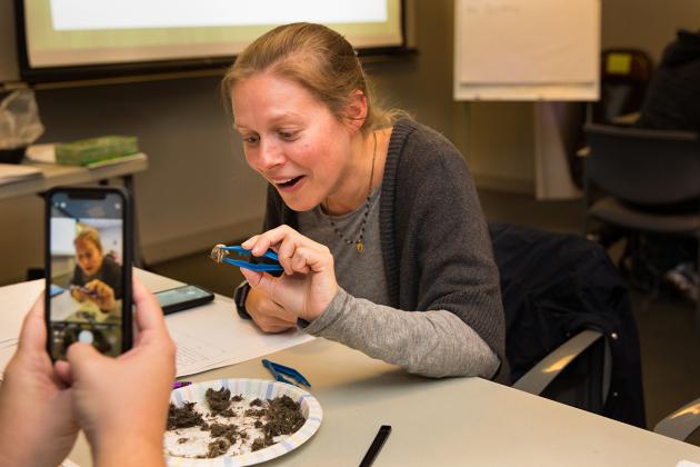 Woman holds owl pellet