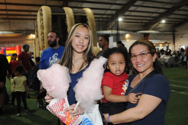 A mother, her daughter and grandson take a group photo at UFT Family Day on March 29, 2025.