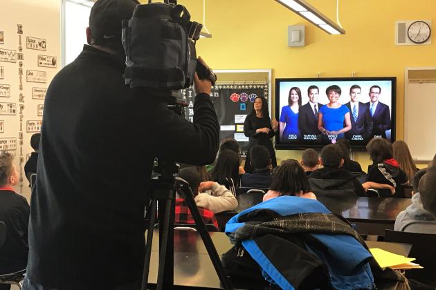 Camera operator filming in classroom 