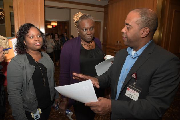 Three standing UFT members talking to each other