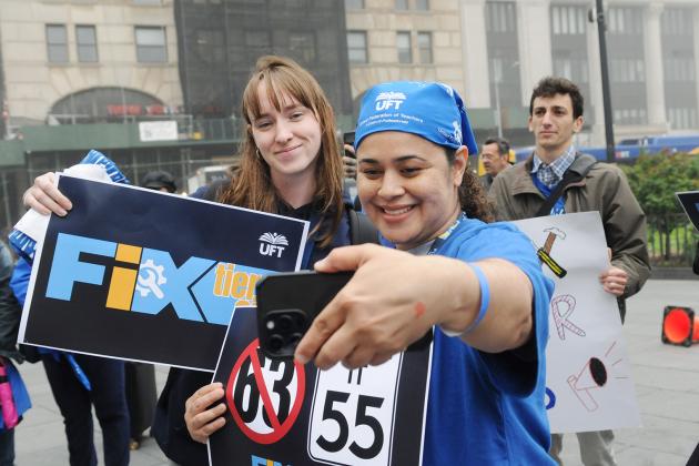 Two UFT members take a selfie at the UFT Fix Tier 6 Rally held at Brooklyn Borough Hall on May 6, 2025.