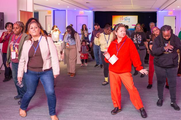 Attendees get on the dance floor at the UFT HERstory brunch on March 15, 2025. 