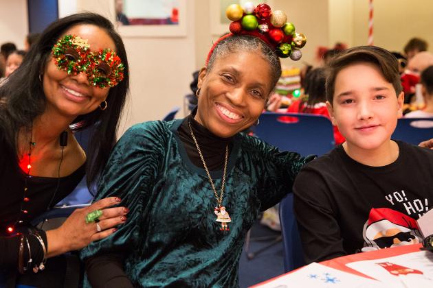 Smiling women wearing Christmas-themed glasses