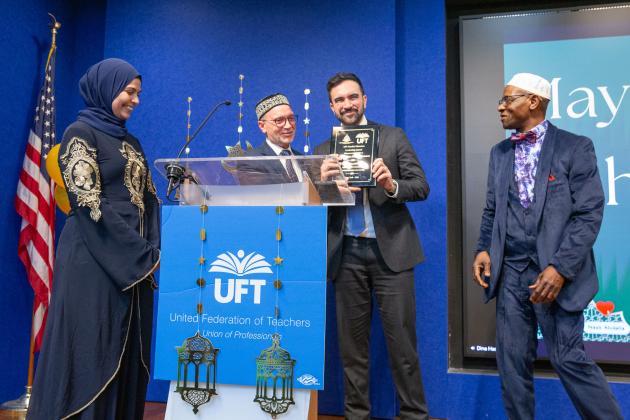 Committee Vice Chair Dina Hassan and committee member Mohammed Bility (far right) look on as committee Chair Abdelhafid Djemil presents Mayor Zohran Mamdani with an award during the UFT's annual Iftar celebration on Feb. 27, 2026. 