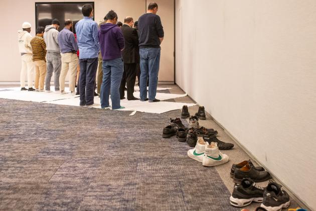 UFT Muslim Educators Committee members and guests gather to pray in a quiet space next to the room where dinner is being served at the UFT Muslim Educators Committee Iftar Dinner on March 7, 2025. 