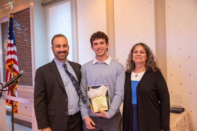 UFT Jewish Heritage Committee Chair Jason Goldberg (left) and UFT Educational Liaison Laurie Lubman present the Student of the Year Award to Yonathan Bar of the Bronx HS of Science at the 2024 UFT Jewish Heritage Committee Tikkun Olam Awards Dinner on Dec. 5, 2024. 