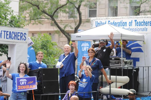 UFT President Michael Mulgrew waves from atop the union float as it passes the reviewing stand on Fifth Avenue during the 2025 NYC Labor Parade