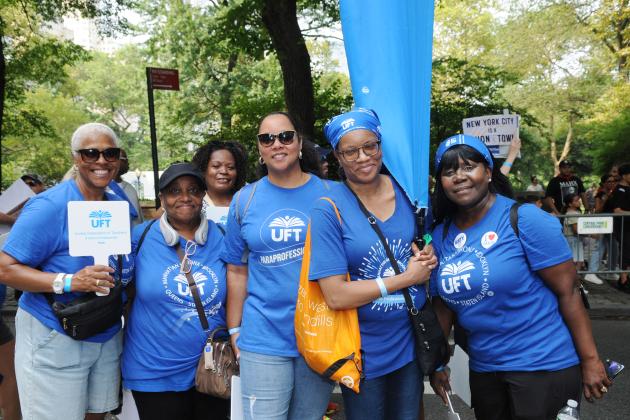 UFT paraprofessionals take a group photo during the 2025 NYC Labor Parade. 