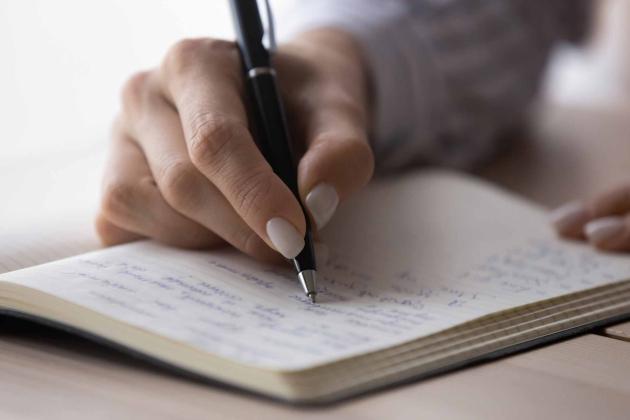 hand writing in a notepad