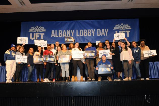District 32 members get onstage at the Convention Center for a group photo after lunch at Lobby Day on March 10, 2025.
