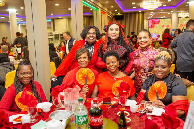 A group of attendees at the 2025 UFT Asian Heritage Committee Lunar New Year Banquet pose for a group photo.