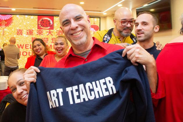 An attendee shows off his sweatshirt  at the UFT Asian Heritage Committee Lunar New Year Banquet on Feb. 28, 2025.