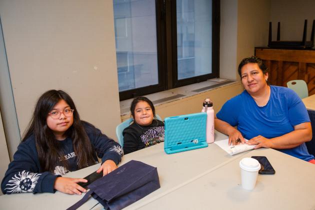 Erika Sarmiento, a Manhattan parent, attends a training on school leadership teams, parent-teacher associations and safety teams with her two children.