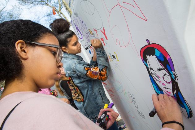 Kids drawing with markers on paper