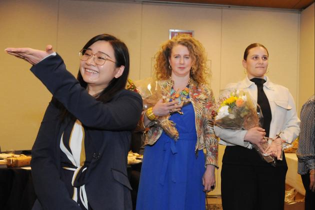 Teacher Jiehua Xuan acknowledges her supporters from IS 220 in Sunset Park, Brooklyn, as she stands to accept her School Culture Award.
