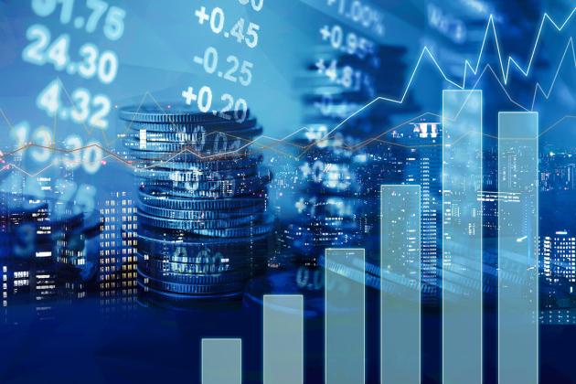 Coins stacked, buildings at night with lights, graph, charts, stock tickers, blue
