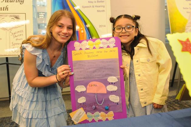 Sophie Lipstein of PS 34 in Brooklyn and her student show off their project, “Speech Showers Help Our Skills Bloom,” which helped the student with articulation goals.
