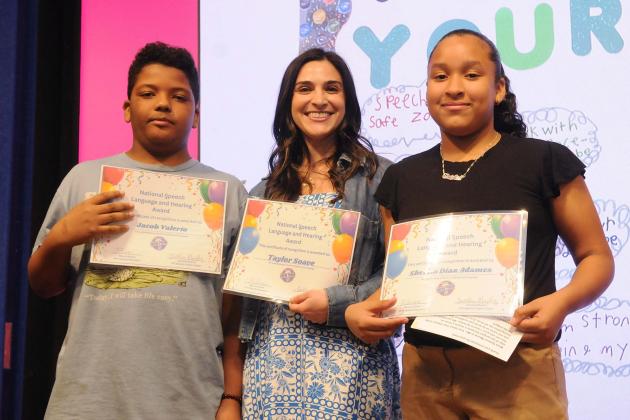 Speech teacher Taylor Soave and her two students from PS 2 in Manhattan accept their award for their project, “Your Voice, Your Choice!”