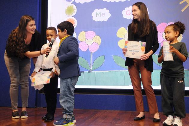 Speech teachers Catherine Keshner (left) and Kelly Opinante of PS 346 in Brooklyn ask their students to describe their project, “Speech Has Helped Me Grow.”