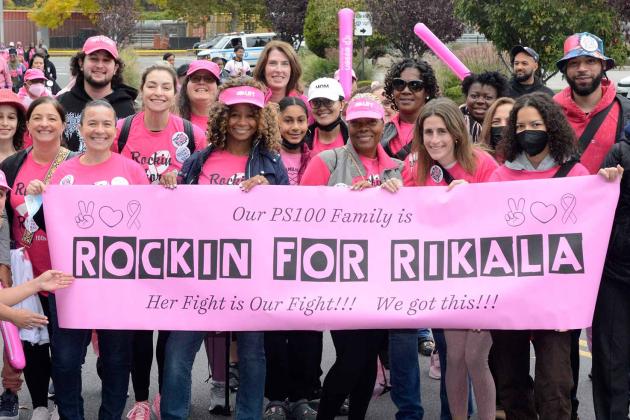 Teachers holding up a banner