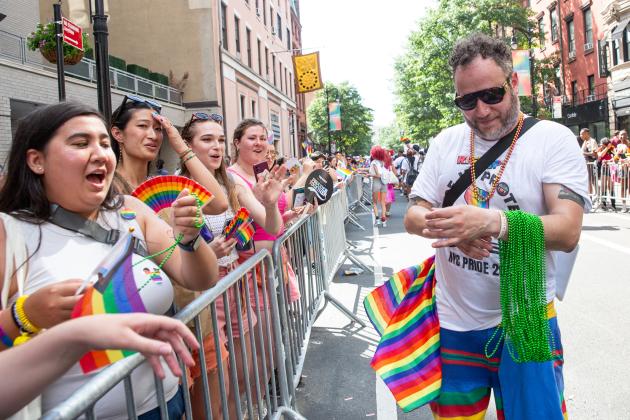 A UFT member hands out beads to parade onlookers at the 2025 NYC Pride March.