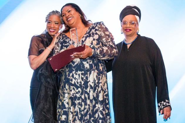 Family Child Care Providers Chapter Leader Tammie Miller (left) and Chapter Vice Chair Melissa Reed (right) congratulate Community Champion Award winner Marvalyn Ricketts.