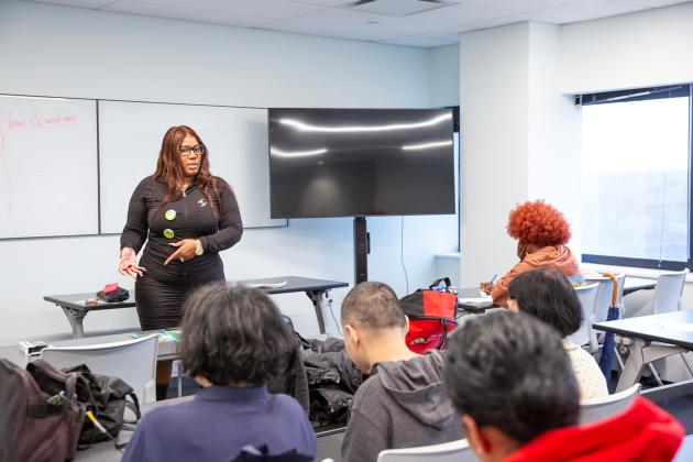 Tanisha Marie Adjokatcher, a financial coach, leads attendees in a personal finances workshop titled “Money Moves.”