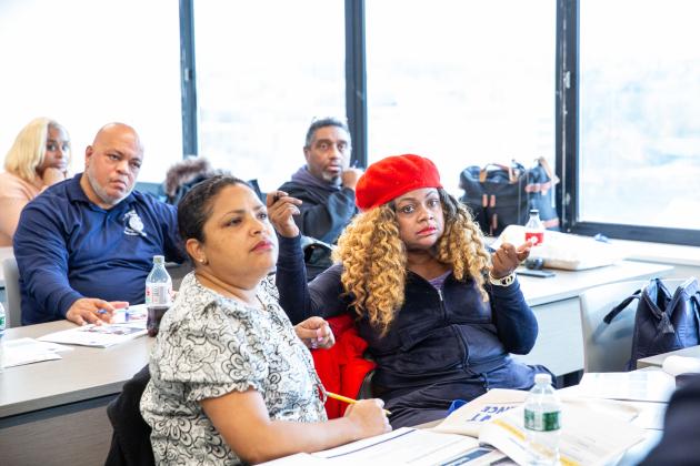 District 24 parent leader Jusinta Jaggassar-Ernul (right) poses a question during the Member to Member Parent Training workshop.