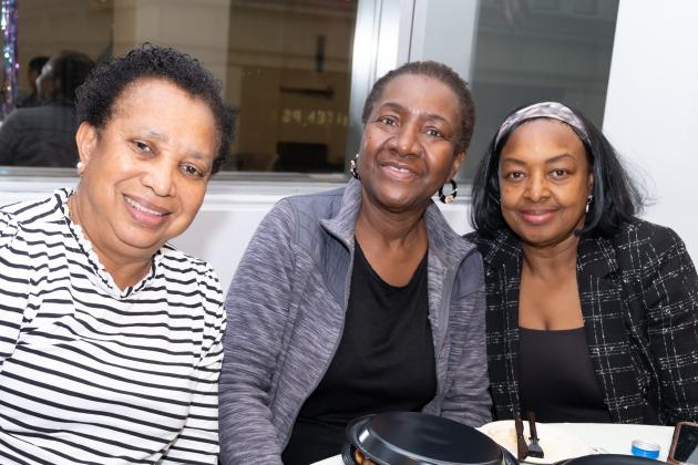 Three women take a photo at a table during the UFT School Nurses Appreciation Dinner on May 7, 2025.