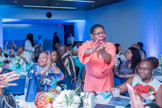 Colleagues cheer an honoree at their table during the UFT School Secretary Awards Soiree on June 6, 2025. 