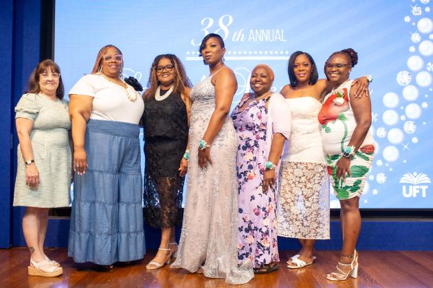 School secretary and Goldie Colodny Award winner Erica Stewart (second from left) of PS 361 in Brooklyn is congratulated by UFT School Secretaries Chapter Leader Sheryl Pender (center) and Stewart’s fellow chapter executive board members at the UFT School Secretary Awards Soiree on June 6, 2025. 