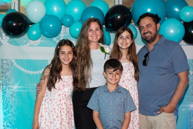 Staten Island honoree Luljeta Ardoli (second from left), school secretary at the Richmond Pre-K Center, is surrounded by her husband and children at the UFT School Secretary Awards Soiree on June 6, 2025. 