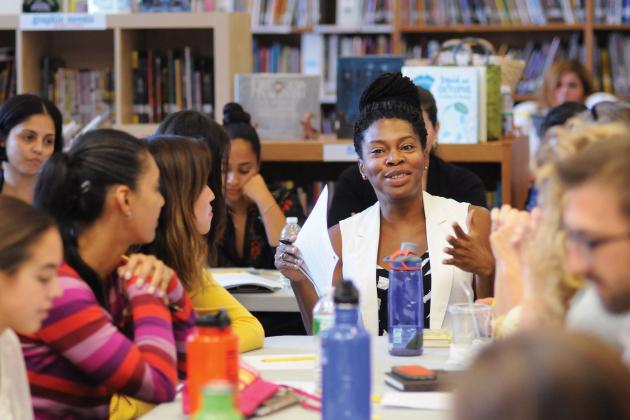 Group of teachers seated in library conversing