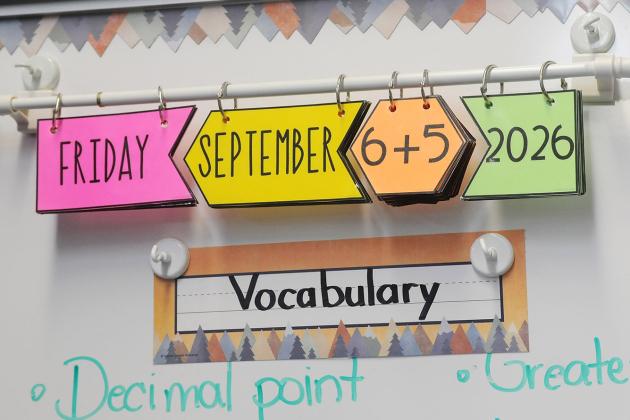 Una-Belinda Titus, 4th grade math teacher at PS 284 in Brooklyn has her students solve a basic math problem to figure out and write the day's date in their notebooks. 